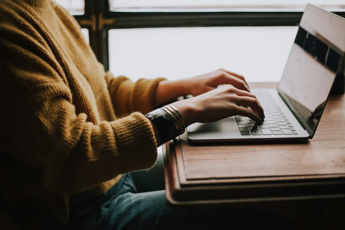 Person working on a laptop researching website costs in Australia